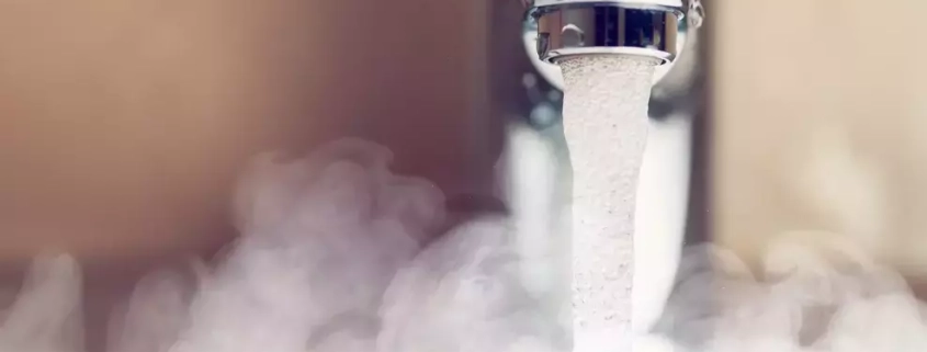 Domestic hot water temperature UK – a picture showing hot water flowing out of a tap