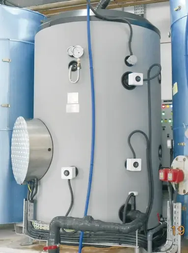 Industrial electric water heater with immersion heaters located in the inspection manhole