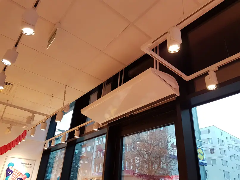 Commercial over door heater air curtain mounted horizontally over a doorway entrance