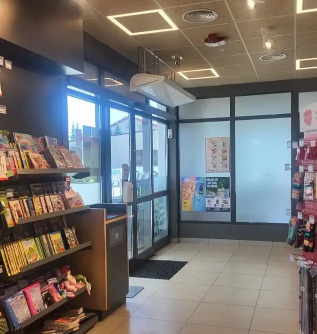 Hot water air curtain installation picture in a shop retail environment, an aesthetically pleasing low profile air curtain.- the air stream range from Flexiheat UK
